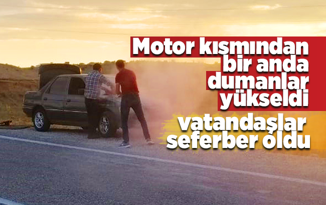 Dumanlar yükselen otomobil için vatandaşlar seferber oldu